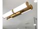 Close up of modern bathroom light fixture with integrated LED lighting and brushed gold hardware at 6047 Blakeford Dr, Windermere, FL 34786