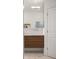 Bathroom features modern vanity with wood-tone cabinets, white countertop, and sleek silver faucet at 6047 Blakeford Dr, Windermere, FL 34786