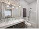 Beautiful bathroom with double sink vanity, freestanding tub, tiled shower and stylish light fixtures at 6047 Blakeford Dr, Windermere, FL 34786
