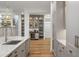 Kitchen featuring custom cabinetry, a bar area, and modern appliances at 6047 Blakeford Dr, Windermere, FL 34786