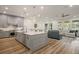 Open-concept kitchen and living room with a large island, stylish seating, and plenty of natural light at 6047 Blakeford Dr, Windermere, FL 34786