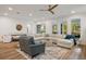 Spacious living room with a comfortable sectional sofa, ample natural light, and a modern ceiling fan at 6047 Blakeford Dr, Windermere, FL 34786