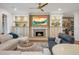 Elegant living room featuring a fireplace, custom built-ins, and stylish, comfortable seating at 6047 Blakeford Dr, Windermere, FL 34786