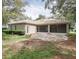 Wide backyard view of a home with a screened lanai and stone patio at 636 Cheviot Ct, Apopka, FL 32712