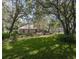 Expansive backyard with lush green lawn and mature trees, offering a peaceful outdoor space at 636 Cheviot Ct, Apopka, FL 32712