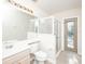Bright bathroom featuring a glass-enclosed shower, a door to the outside, and a neutral color scheme at 636 Cheviot Ct, Apopka, FL 32712