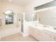 Bright bathroom with soaking tub, separate glass shower, and vanity with double sinks at 636 Cheviot Ct, Apopka, FL 32712