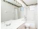 Well-lit bathroom features a large mirror, combination shower and tub, and palm tree-themed wallpaper border at 636 Cheviot Ct, Apopka, FL 32712