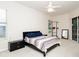 Bright bedroom with a ceiling fan, a window, and a glass sliding door to the outside at 636 Cheviot Ct, Apopka, FL 32712