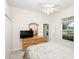 Bright bedroom features a dresser with a mirror, closet, and window at 636 Cheviot Ct, Apopka, FL 32712