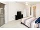 This bedroom has neutral walls, carpet, and a large dresser with a television at 636 Cheviot Ct, Apopka, FL 32712