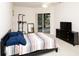 This is a bedroom with neutral walls, dark furniture, and a view of the patio at 636 Cheviot Ct, Apopka, FL 32712