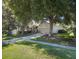 Single-story home with a two car garage surrounded by mature trees at 636 Cheviot Ct, Apopka, FL 32712