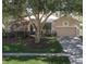 Charming single-story home with a well-maintained front yard and a two-car garage at 636 Cheviot Ct, Apopka, FL 32712