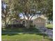 Charming single-story home with a well-manicured lawn, mature trees, and inviting curb appeal at 636 Cheviot Ct, Apopka, FL 32712