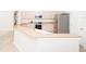 Bright kitchen features tan countertops, white cabinets, stainless steel appliances, and a breakfast bar area at 636 Cheviot Ct, Apopka, FL 32712