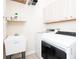 Well-lit laundry room equipped with a sink, washer, and dryer at 636 Cheviot Ct, Apopka, FL 32712