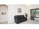 Cozy living room featuring neutral decor, sliding glass doors, and comfortable seating at 636 Cheviot Ct, Apopka, FL 32712