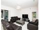 Cozy living room with ceiling fan, TV setup, and leather seating for relaxing and entertainment at 636 Cheviot Ct, Apopka, FL 32712