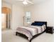 Bright main bedroom featuring a queen-sized bed with a striped coverlet and a connecting bathroom at 636 Cheviot Ct, Apopka, FL 32712