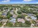 Aerial view of a neighborhood with tree-lined streets and homes with private pools, providing a serene setting at 6970 Knightswood Dr, Orlando, FL 32818