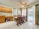Dining area with wood table, chairs, tile floor, and sliding glass doors leading to pool at 6970 Knightswood Dr, Orlando, FL 32818