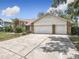 Spacious two-car garage with a wide driveway and well-maintained exterior, offering ample parking at 6970 Knightswood Dr, Orlando, FL 32818