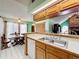 Bright kitchen with breakfast bar and a view into the dining area at 6970 Knightswood Dr, Orlando, FL 32818