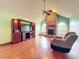 Cozy living room with a brick fireplace, hardwood floors, and ample natural light for a warm ambiance at 6970 Knightswood Dr, Orlando, FL 32818