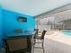 Inviting outdoor seating area with a table, chairs, and television, perfect for entertaining near the pool at 6970 Knightswood Dr, Orlando, FL 32818