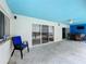 Covered patio space with stylish seating areas, ideal for enjoying the outdoors near the pool at 6970 Knightswood Dr, Orlando, FL 32818