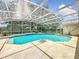 Inviting screened-in pool area with clear blue water, perfect for relaxation and outdoor entertainment at 6970 Knightswood Dr, Orlando, FL 32818