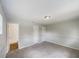 Bedroom featuring carpet flooring, neutral paint, and entry to bathroom at 7040 Hennepin Blvd, Orlando, FL 32818