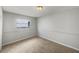 Clean, carpeted bedroom with neutral walls and a window providing natural light at 7040 Hennepin Blvd, Orlando, FL 32818