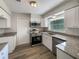 Modern kitchen with stainless steel appliances, granite countertops, and white cabinets at 7040 Hennepin Blvd, Orlando, FL 32818