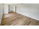 Spacious empty living room featuring luxury vinyl floors, neutral paint and great natural light at 7040 Hennepin Blvd, Orlando, FL 32818