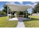 Outdoor patio under a canopy with a table and chairs for relaxing and enjoying the backyard at 7102 Easter St, Winter Park, FL 32792