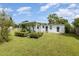 A lush green backyard featuring a charming patio area, perfect for outdoor entertainment and relaxation at 7102 Easter St, Winter Park, FL 32792
