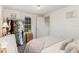 Bedroom with a bed, a closet with clothes hanging, and a view of the backyard through a window at 7102 Easter St, Winter Park, FL 32792