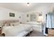Bright bedroom featuring a large bed, a large mirror, and a dresser with a clean, modern design at 7102 Easter St, Winter Park, FL 32792