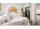 Bright bedroom with a bed, a closet with clothes, and a decorative fan hanging on the wall at 7102 Easter St, Winter Park, FL 32792