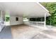 Spacious covered carport with a fenced-in area and ample parking space at 7102 Easter St, Winter Park, FL 32792