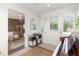 Inviting entryway with piano, leading into a spacious living area with natural light and stylish decor at 7102 Easter St, Winter Park, FL 32792