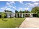 Charming single-story home with a covered carport and well-maintained front yard at 7102 Easter St, Winter Park, FL 32792