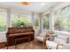 Bright sunroom featuring a piano, seating, and natural light, creating a peaceful and inviting space at 7102 Easter St, Winter Park, FL 32792