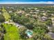 An aerial view of the community pool with multiple homes nearby surrounded by trees at 748 Andover Cir, Winter Springs, FL 32708