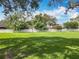 Fenced backyard with expansive grassy lawn and mature shade trees at 748 Andover Cir, Winter Springs, FL 32708