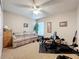 Neutral bedroom featuring a sofa and fitness equipment under a ceiling fan and bright natural light at 748 Andover Cir, Winter Springs, FL 32708