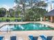 A sparkling swimming pool, surrounded by lounge chairs, awaits residents at 748 Andover Cir, Winter Springs, FL 32708