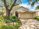 Charming single-story home featuring a brick driveway, well-maintained landscaping and an attached two-car garage at 748 Andover Cir, Winter Springs, FL 32708